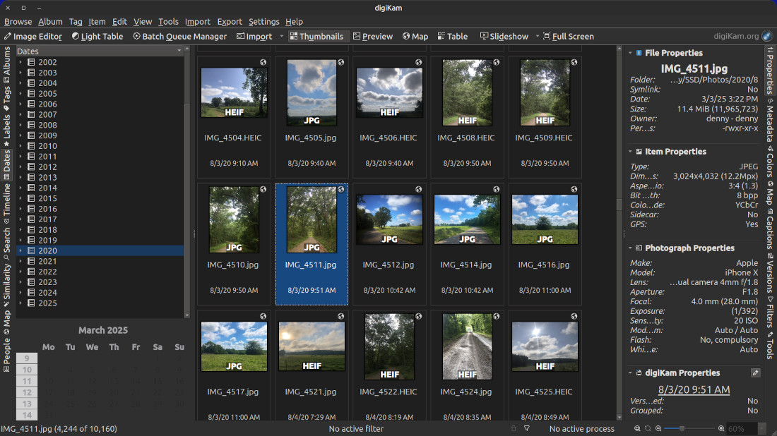 A screenshot of the digiKam app showing the dates browser on the left side panel of the application. The center portion of the application window shows large thumbnails of images and the imege properties in use on the right side panel of the window.